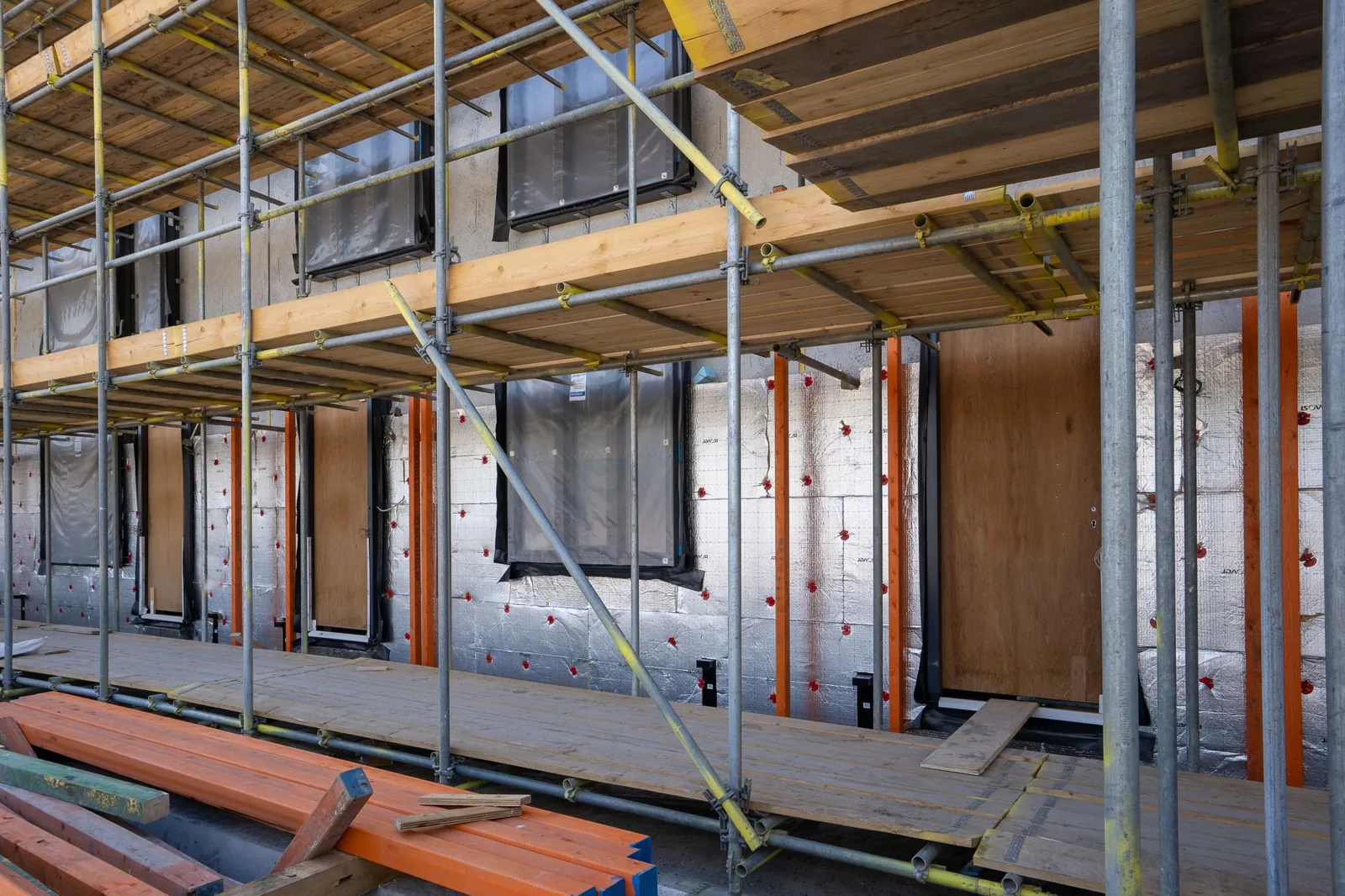 Garage insulation guide showing fiberglass batt installation between wall studs
