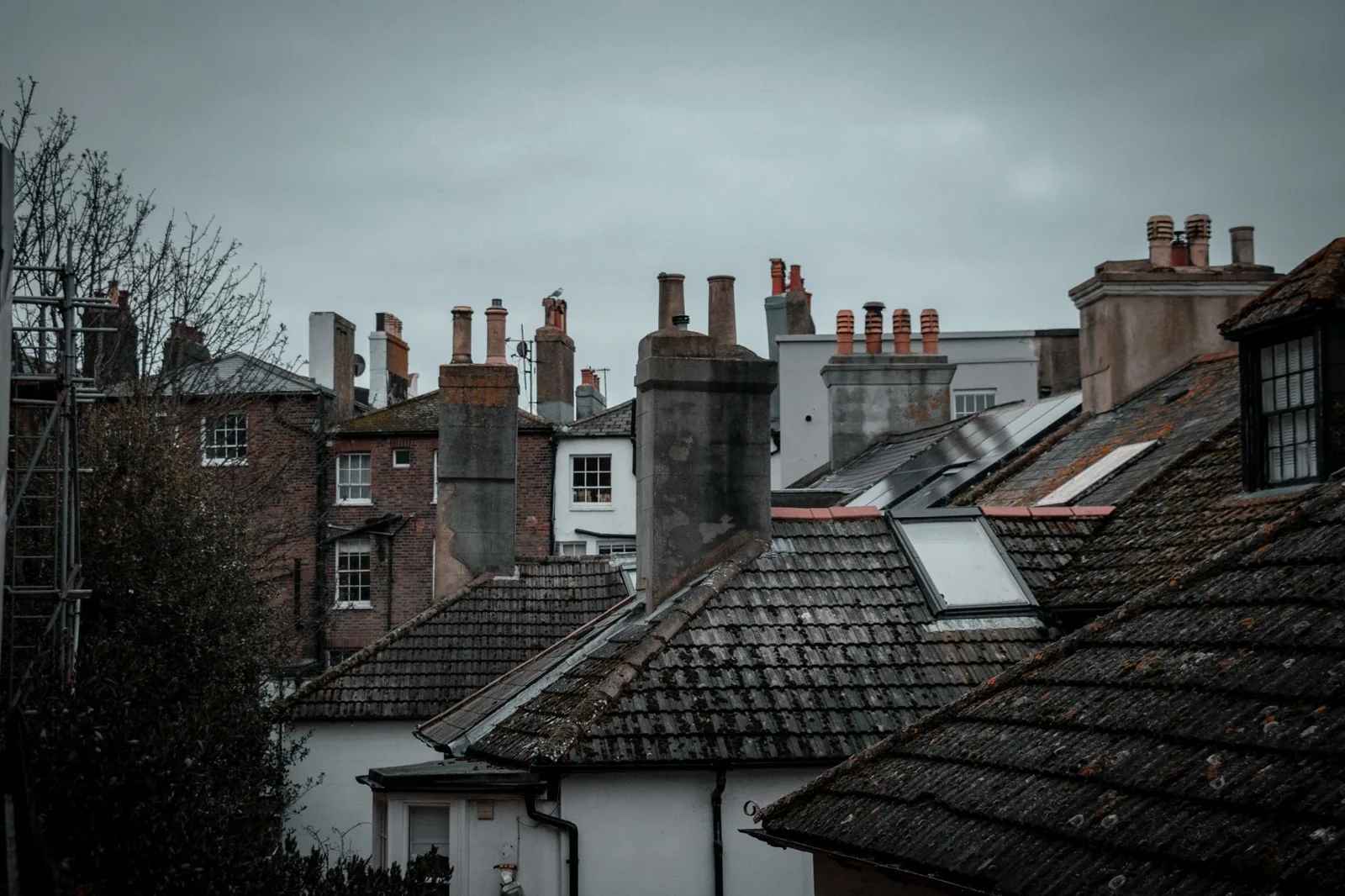 A cracked chimney crown needs sealing before water damage spreads into the masonry below