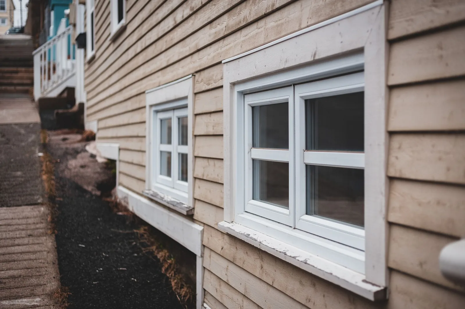 Applying a smooth bead of exterior caulk along a siding seam