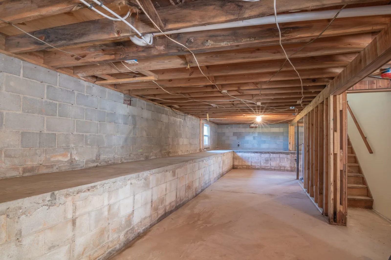 Repairing and sealing a concrete foundation wall during exterior waterproofing